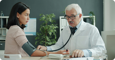 Doctor measuring a patient's blood pressure during a consultation